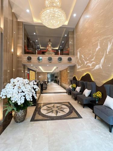a lobby of a hotel with couches and flowers at Skylark Hotel & Spa Ha Noi in Hanoi