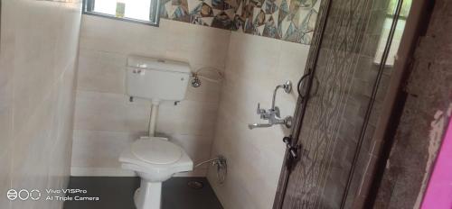 a bathroom with a toilet and a shower at Vishal lake farm in Lavasa