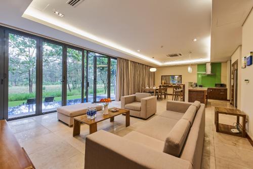 a living room with a couch and a table at Ocean Luxury Villas Danang in Danang