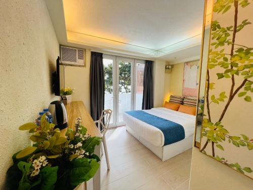 a hotel room with a bed and a table and a mirror at Concerto Inn in Hong Kong