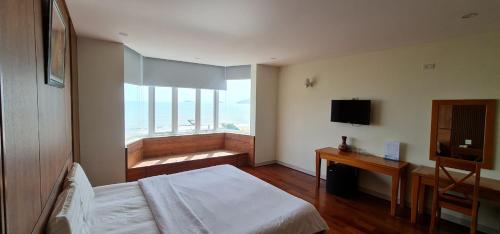 a bedroom with a bed and a large window at Ly Ky Hotel in Quy Nhon