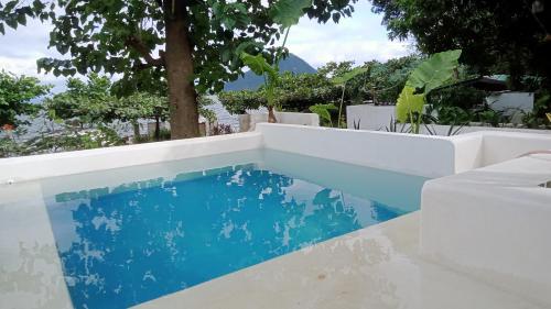 a pool in the backyard of a house with blue water at Baywalk Suites Batangas in Laurel