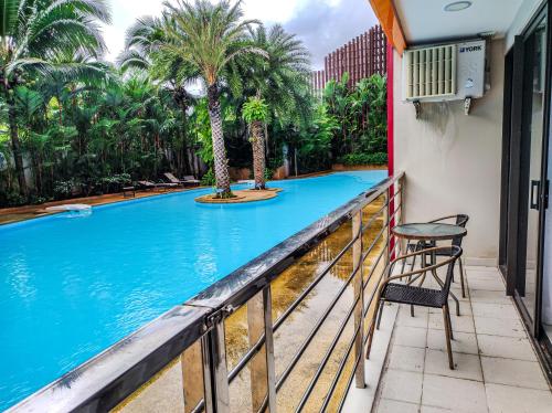 a balcony with a view of a swimming pool at MBC Mai Khao Beach Condotel LUXURY APARTMENTs in Phuket Town