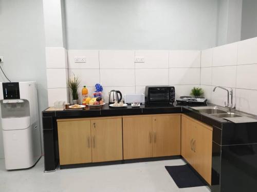 a kitchen with a sink and a refrigerator at MyPods @ Bukit Bintang in Kuala Lumpur