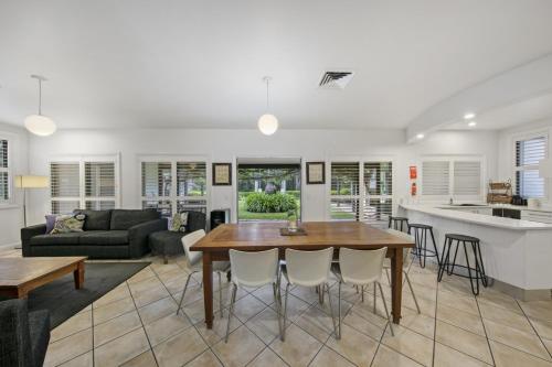a kitchen and living room with a table and chairs at The Woods Pokolbin in Pokolbin
