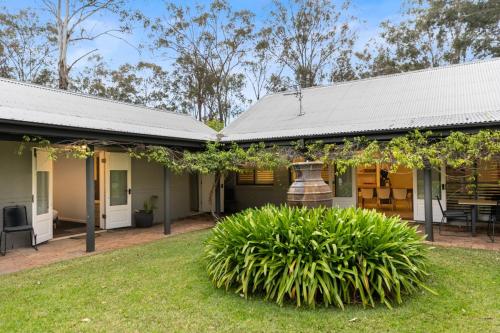 a house with a yard in front of it at The Woods Pokolbin in Pokolbin