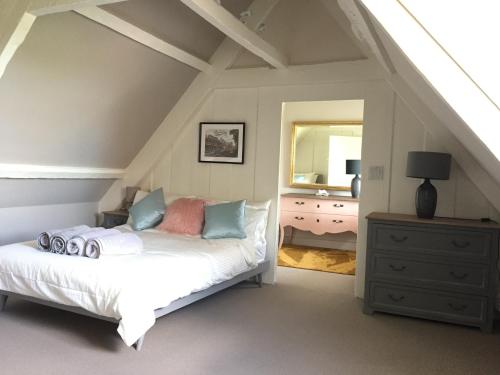 a bedroom with a bed and a dresser and a mirror at Beautiful Georgian House located in Blandford in Blandford Forum