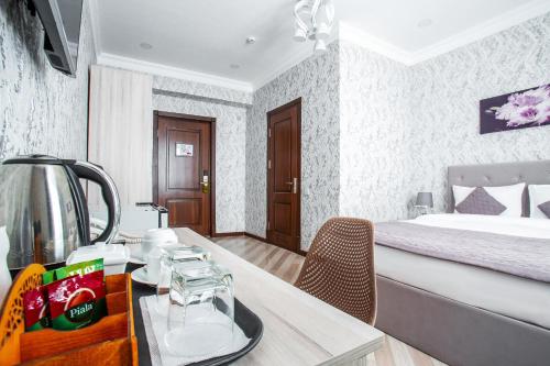 a hotel room with a bed and a dining table at Manifa Hotel in Tashkent