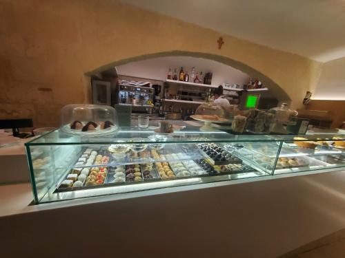 a display case in a bakery with many different pastries at QUART0 GREC0 Suite 17 in Altamura