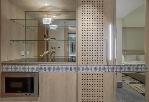 a room with a counter with a sink and a mirror at Ewaa Express Hotel - Al Shati in Jeddah