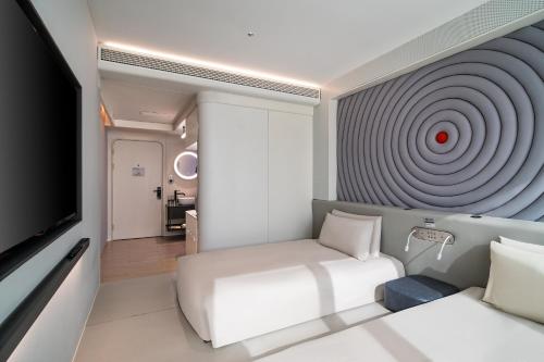 a room with a bed and a target on the wall at Atour X Shanghai Huaihai Middle Road in Shanghai