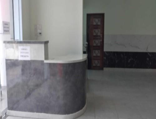 a hallway with a counter in a building with a door at HOTEL HOLIDAY HOME, DAUSA in Dausa