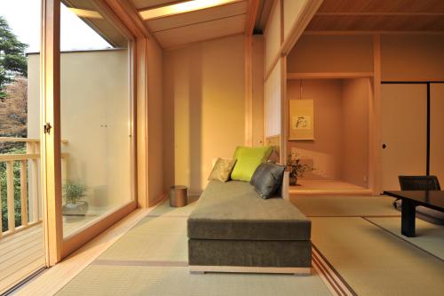 a living room with a couch on a porch at Gora Kadan in Hakone