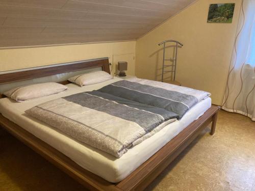 een slaapkamer met een groot bed met een houten frame bij Ferienwohnung "Casa Horife" in Konz