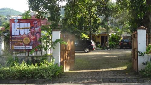 a gate to a house with a sign on it at Kivu Beach Garden in Gisenyi