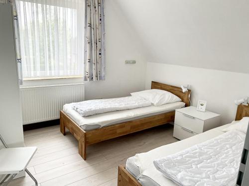 Postel nebo postele na pokoji v ubytování Haus Schwalbennest