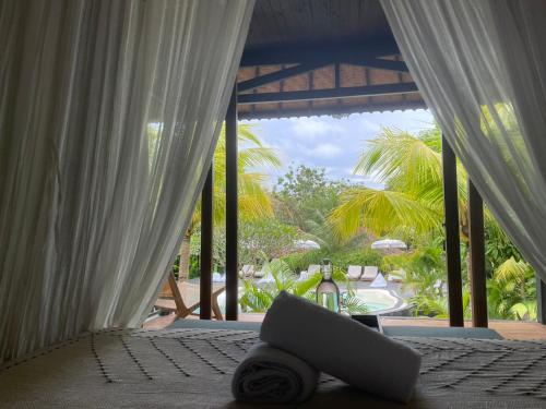 a laptop computer sitting on a bed in a room at ONAYA Bali Resort - Adults Only in Uluwatu