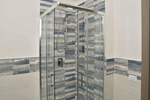 a shower with a glass door in a bathroom at Villa Caravaggio Comfort e Relax in Rocca San Giovanni