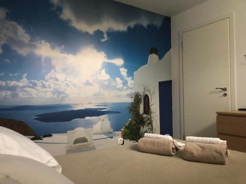 a bedroom with a wall mural of a sky and water at Lavender Suite 