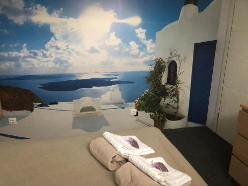 a room with two towels on a bed with a mural at Lavender Suite 