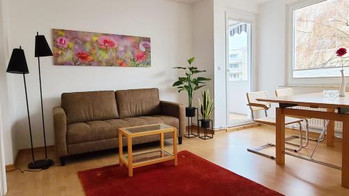 a living room with a couch and a table at Deine Oase mitten in Hannover. in Hannover