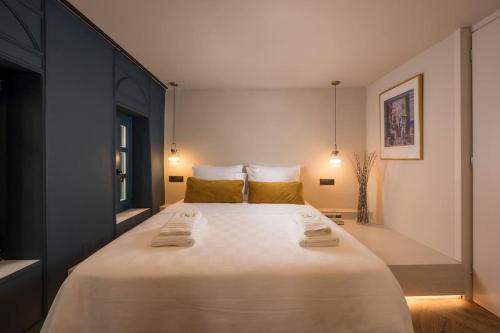 ハニア・タウンにあるTo Ble Hani, the old town houseの大きな白いベッドと黄色い枕のある寝室