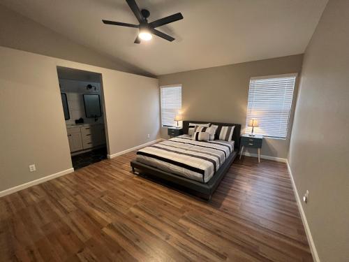 a bedroom with a bed and a ceiling fan at Large Pool & Patio Cozy Single Story Family House in Las Vegas