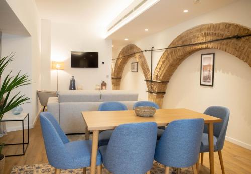 comedor con mesa y sillas azules en nQn Aparts & Suites Sevilla en Sevilla