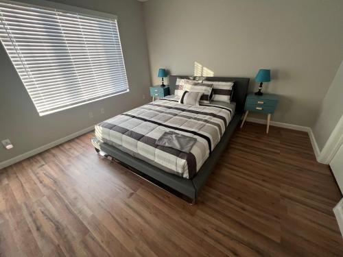 a bedroom with a large bed and a window at Large Pool & Patio Cozy Single Story Family House in Las Vegas