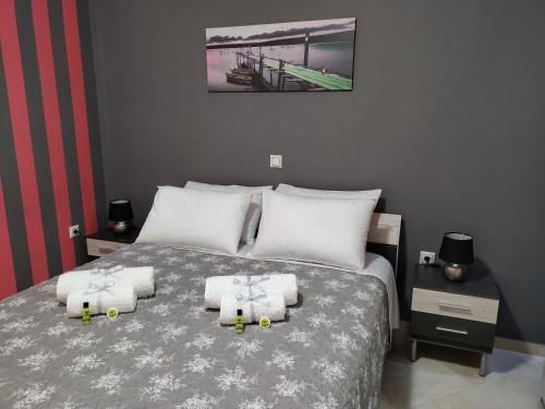 um quarto com uma cama grande e toalhas em Silver Pearl Apartment em Potamós