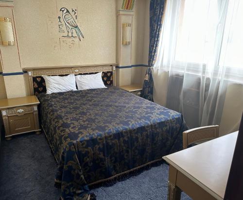 a hotel room with a bed and a window at Отель Фараон in Kyiv