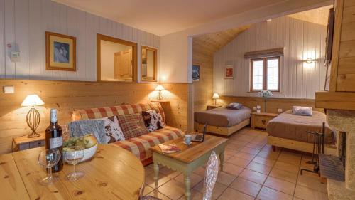a living room with a couch and a table at Cosy Appart'Hotel - Panoramic Village - La Grave in La Grave