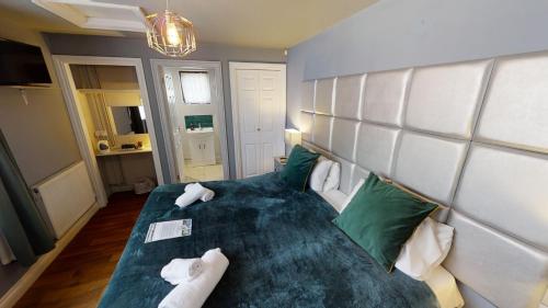 Ένα ή περισσότερα κρεβάτια σε δωμάτιο στο The Farmers Boy Inn Guest House