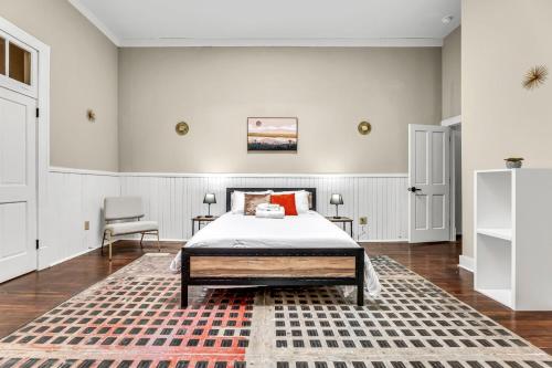 a bedroom with a bed and a rug at Elm St Retro Retreat- Downtown Close to Local Amenities in Greensboro