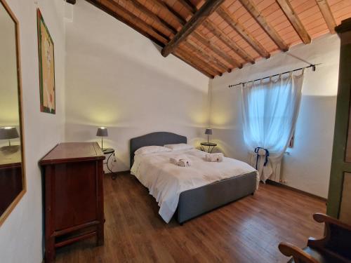 a bedroom with a large bed and a wooden floor at Le Antiche Mura in Florence