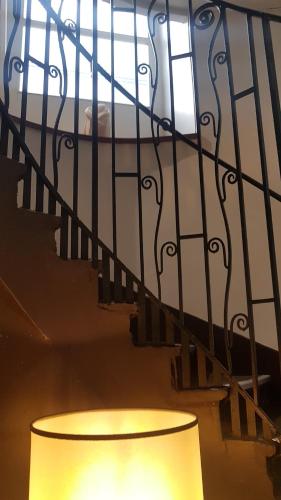 a lamp sitting next to a metal stair railing at Hôtel Le Colisée in Paris