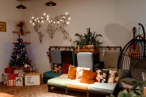 a living room with a christmas tree and a couch at Prague Dream Hostel in Prague
