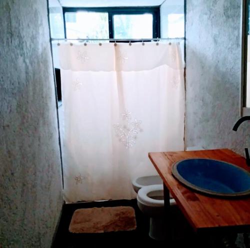 a bathroom with a toilet and a sink and a shower at Cabaña Los Algarrobos in Los Algarrobos