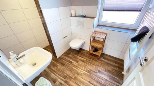 a small bathroom with a sink and a toilet at "Bauernhof-Claussen", Haus Möwe in Sahrensdorf