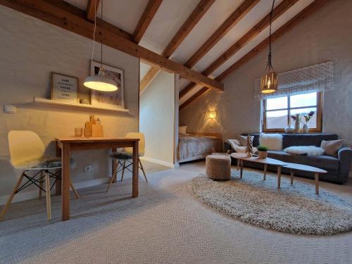a living room with a table and a couch at Ferienwohnung-Kuschelzeit in Pfronten