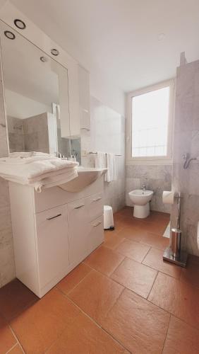 a white bathroom with a sink and a toilet at CharmeRooms Villa Moroni La Depandance in Stezzano