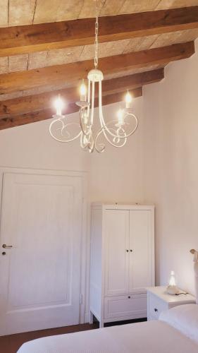 a chandelier hanging from a ceiling in a bedroom at CharmeRooms Villa Moroni La Depandance in Stezzano