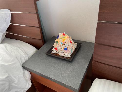a birthday cake on a table in a bedroom at Dining & Stay 38 Miyahira in Zamami