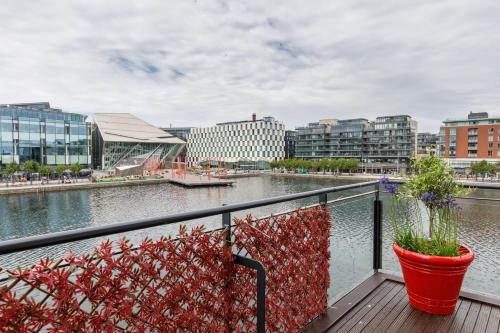 a balcony with a view of a river and buildings at The Curve, Millennium Tower in Dublin