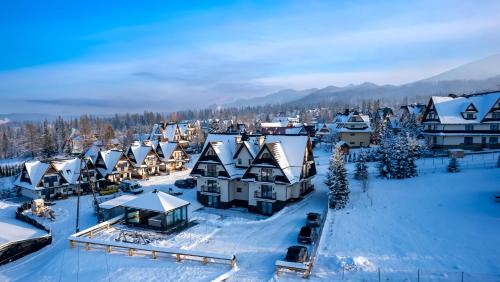 an aerial view of a village covered in snow at Royal Apartments & Spa Zakopane-Cyrhla in Zakopane