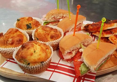 a plate of sandwiches and biscuits on a table at Accòmodati - Camere e Appartamenti in Marina di Gioiosa Ionica