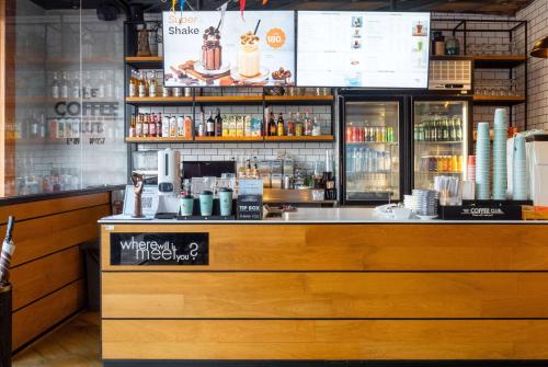 a bar in a restaurant with a counter at Days Inn by Wyndham Patong Beach Phuket - SHA Extra Plus in Patong Beach