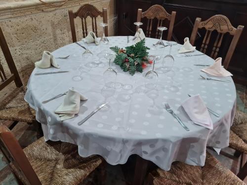a white table with a christmas centerpiece on it at Hostal El Hidalgo in Villaluenga