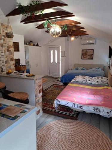 a bedroom with two beds and a kitchen in it at Studio Apartments KIM - Dilberovic in Mostar