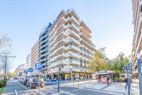 a tall building on a city street with cars parked at republica83-Lisbonhome in Lisbon